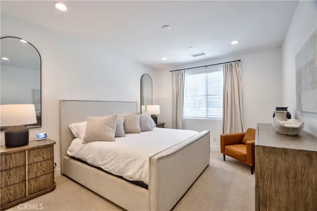 a bedroom with a bed and a lamp