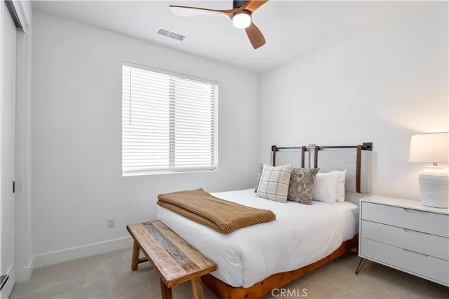 a bathroom with a granite countertop sink mirror vanity and toilet
