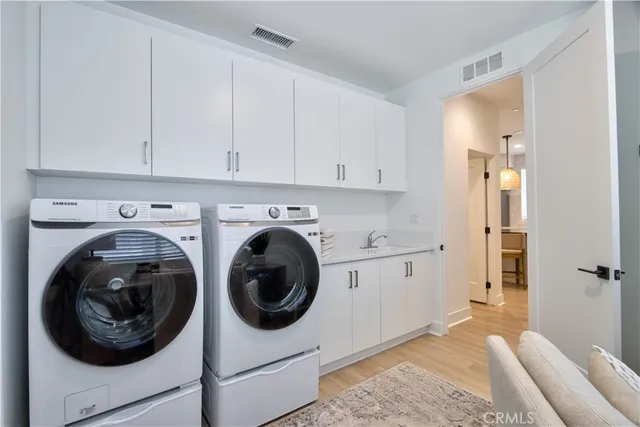 a balcony with chairs and a potted plant