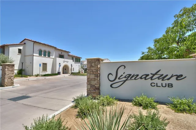 an aerial view of residential houses with outdoor space and parking