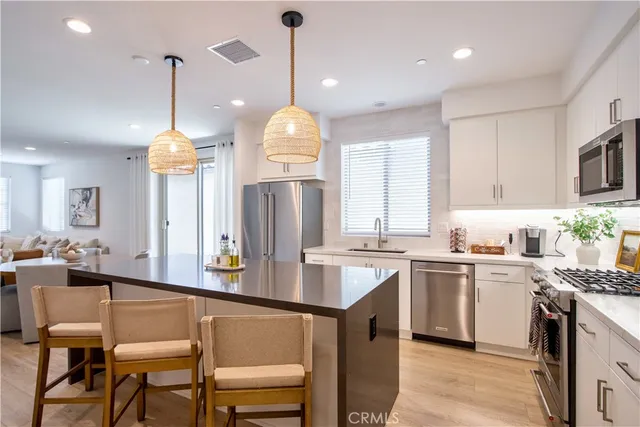 a kitchen with sink a stove and cabinets