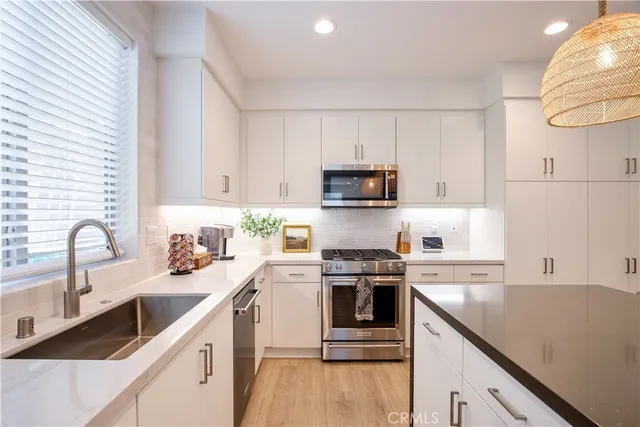 a kitchen with counter space and living room