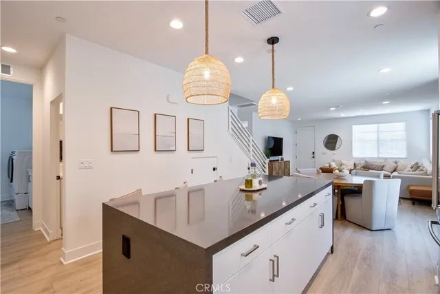 a kitchen with stainless steel appliances granite countertop a sink a stove and a refrigerator