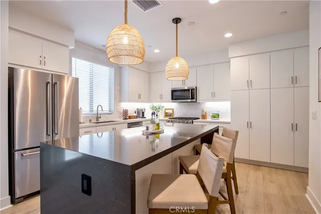 a living room with furniture a flat screen tv and a table