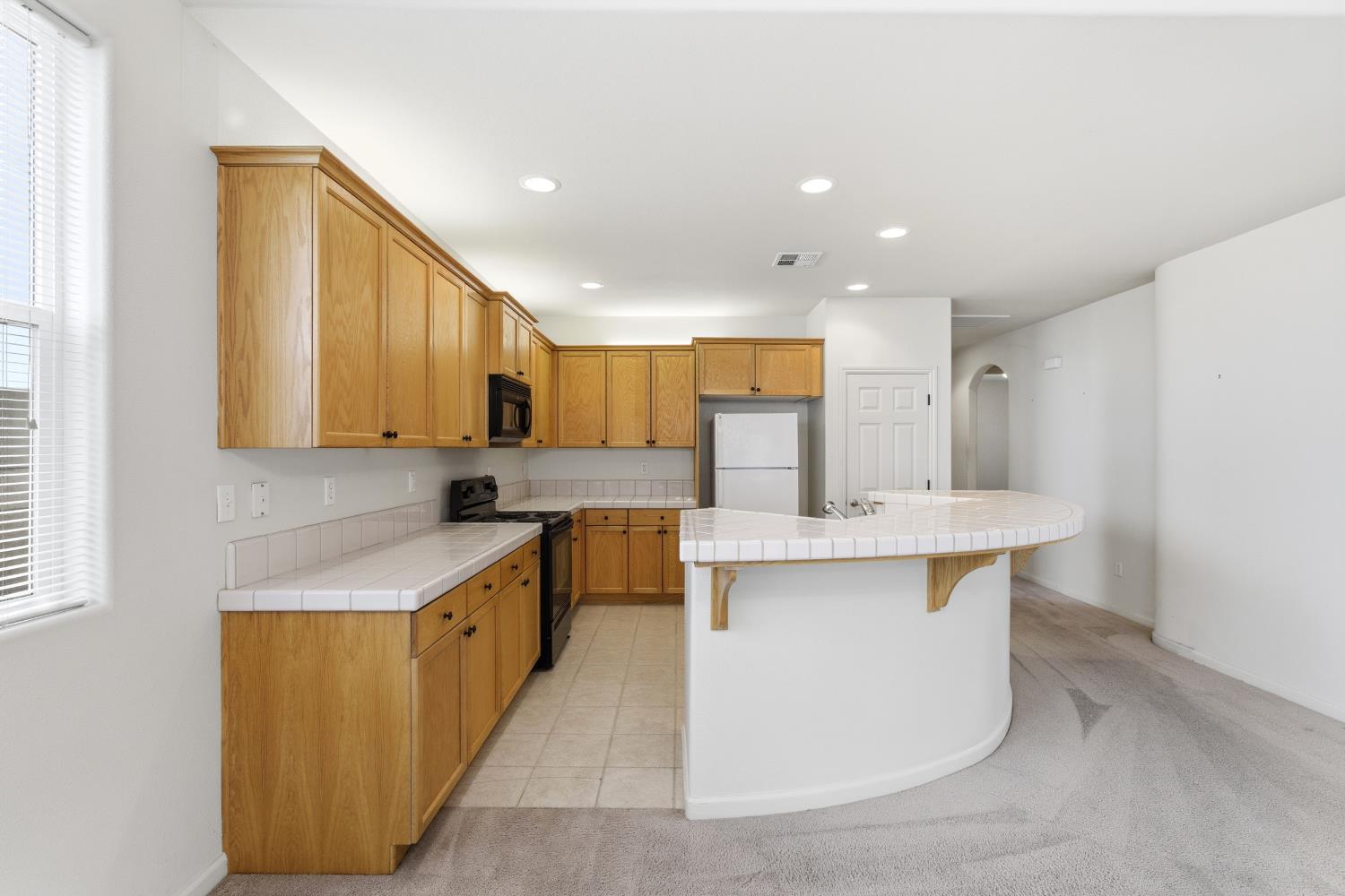 2450 Como Corte Chowchilla, CA 93610 - Photo 11 of 42 a kitchen with stainless steel appliances a sink stove and cabinets