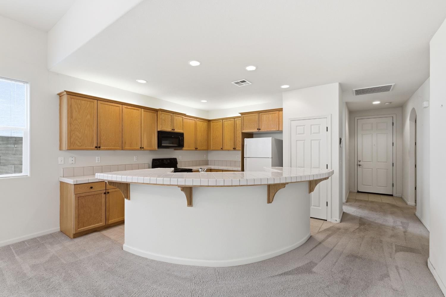 2450 Como Corte Chowchilla, CA 93610 - Photo 12 of 42 a large kitchen with stainless steel appliances a stove a sink a refrigerator and a microwave