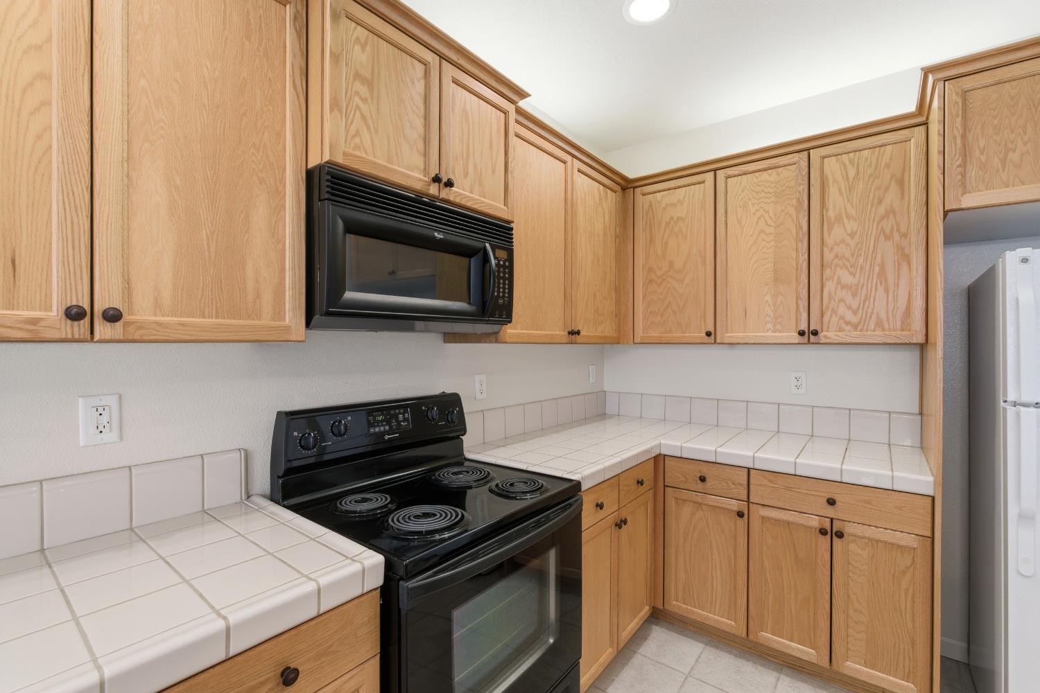 2450 Como Corte Chowchilla, CA 93610 - Photo 15 of 42 a kitchen with granite countertop white cabinets stainless steel appliances and a sink