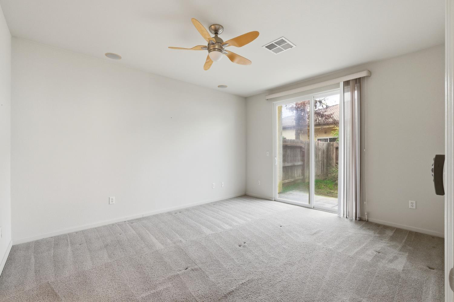 2450 Como Corte Chowchilla, CA 93610 - Photo 18 of 42 an empty room with fan and windows