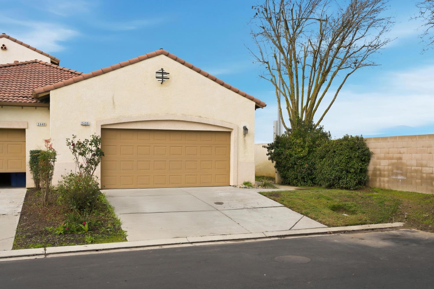 2450 Como Corte Chowchilla, CA 93610 - Photo 2 of 42 a front view of a house with a yard and garage
