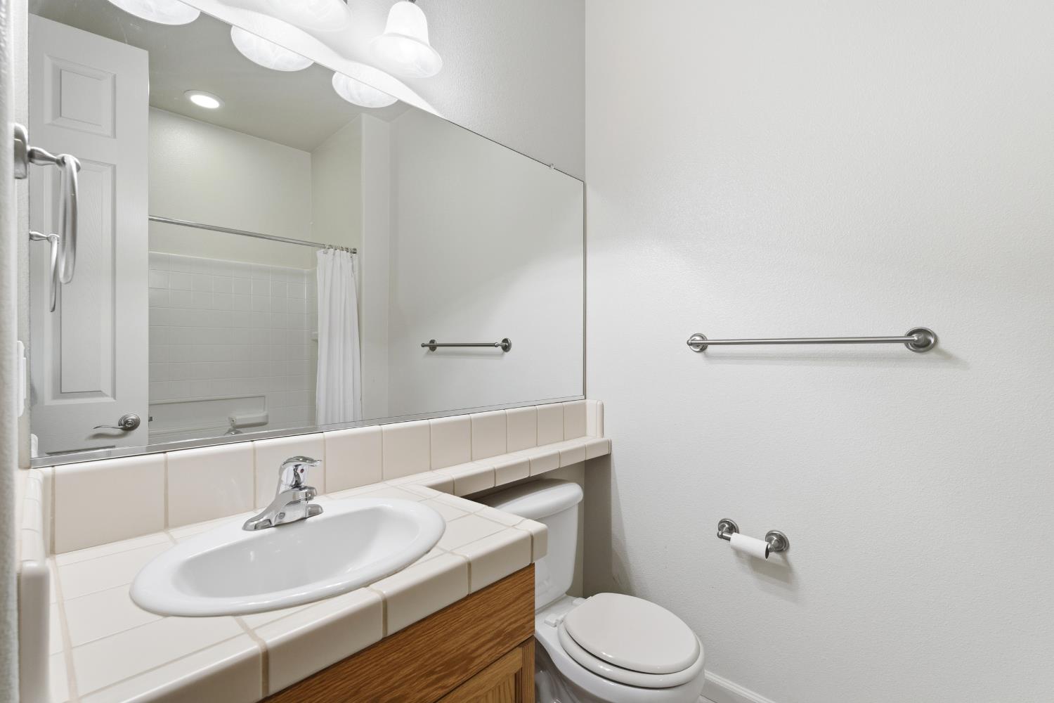 2450 Como Corte Chowchilla, CA 93610 - Photo 26 of 42 a bathroom with a sink toilet a mirror and shower