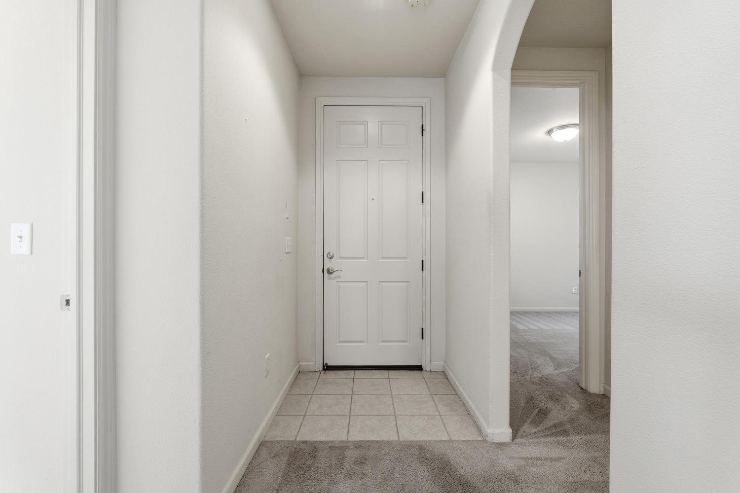 2450 Como Corte Chowchilla, CA 93610 - Photo 5 of 42 a view of a bathroom from a hallway