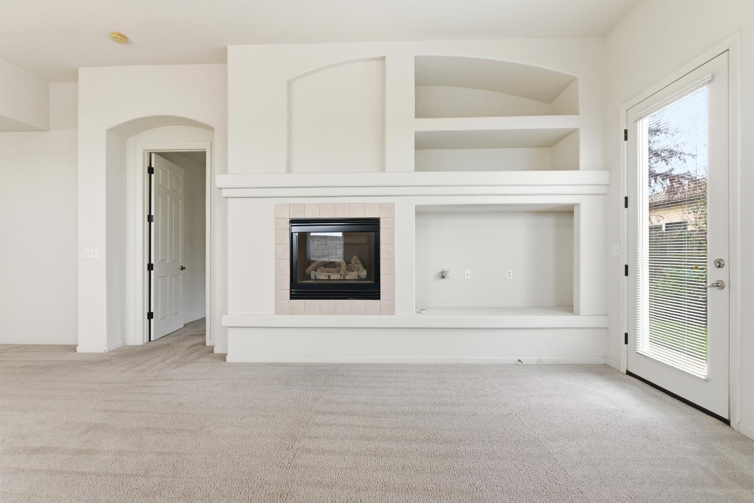 2450 Como Corte Chowchilla, CA 93610 - Photo 10 of 42 wooden floor with a fireplace in it