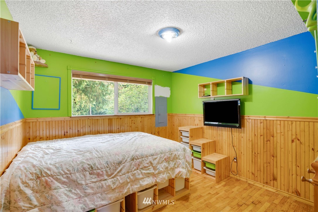 16619 192nd Avenue Southeast Renton, WA 98058 - Photo 13 of 37 a bedroom with a bed and a flat screen tv
