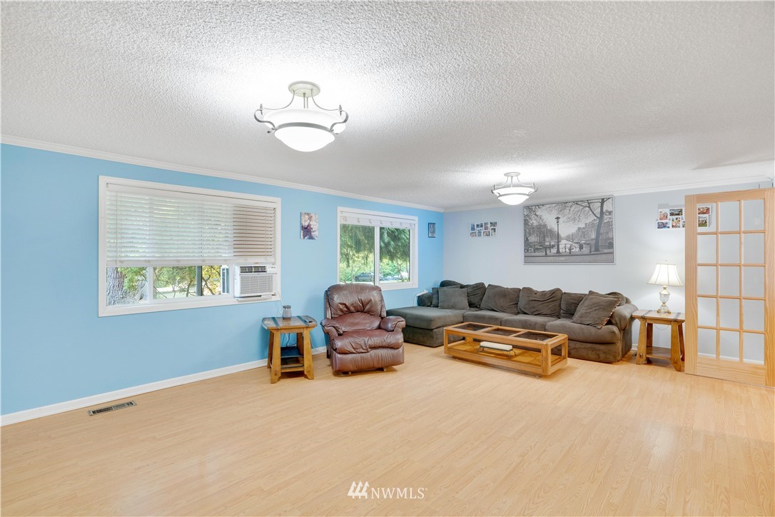 16619 192nd Avenue Southeast Renton, WA 98058 - Photo 16 of 37 a living room with furniture a chandelier and a window