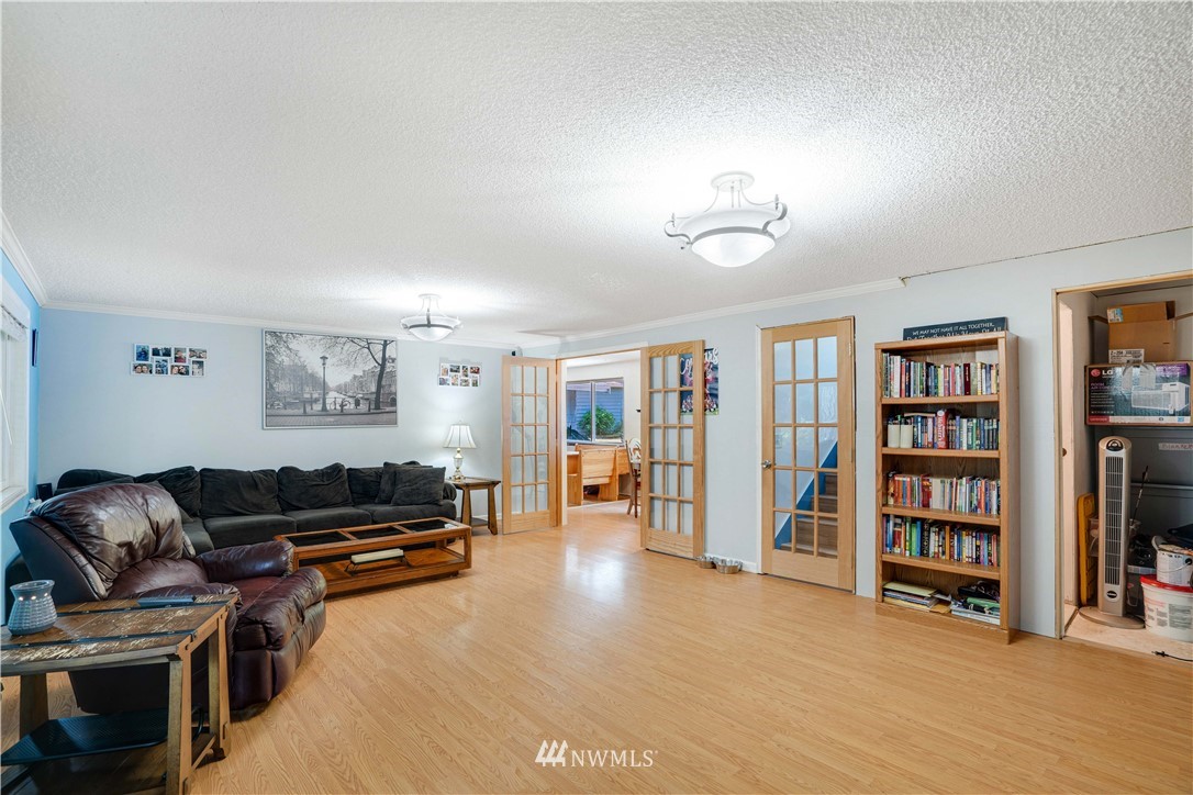 16619 192nd Avenue Southeast Renton, WA 98058 - Photo 17 of 37 a living room with furniture and a book shelf