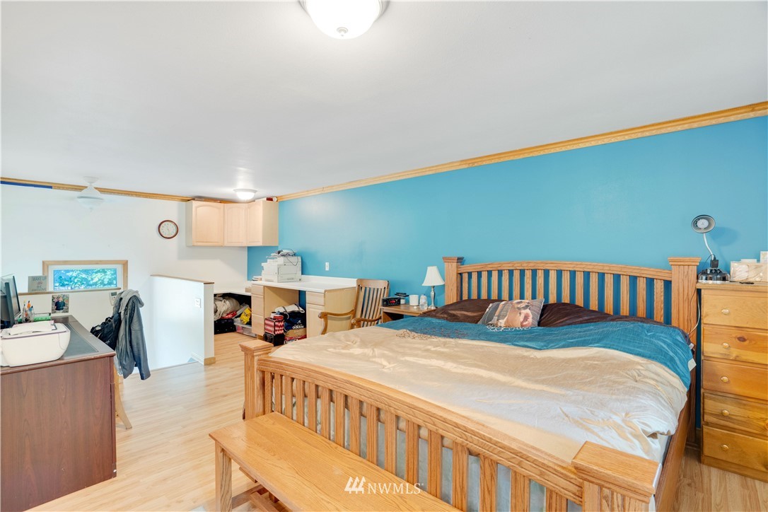 16619 192nd Avenue Southeast Renton, WA 98058 - Photo 21 of 37 a large bedroom with a bed and a table in it