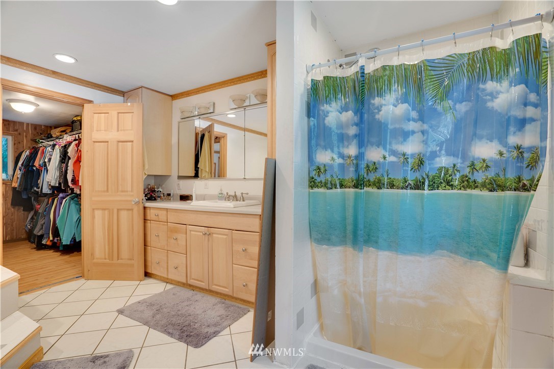 16619 192nd Avenue Southeast Renton, WA 98058 - Photo 24 of 37 a bathroom with a shower a mirror and a sink