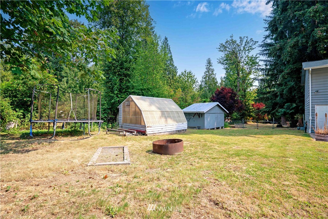 16619 192nd Avenue Southeast Renton, WA 98058 - Photo 33 of 37 a front view of a house with a yard and trees