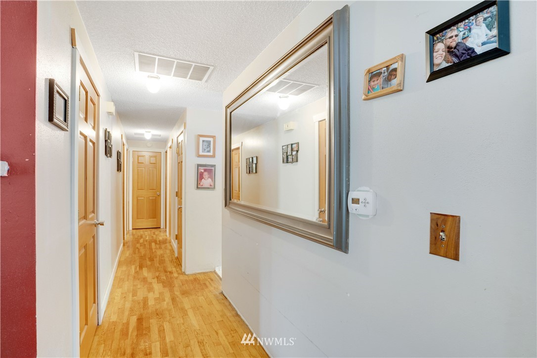 16619 192nd Avenue Southeast Renton, WA 98058 - Photo 5 of 37 a view of a hallway with wooden floor