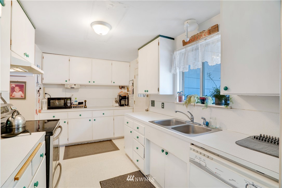 16619 192nd Avenue Southeast Renton, WA 98058 - Photo 7 of 37 a kitchen with cabinets a sink and appliances