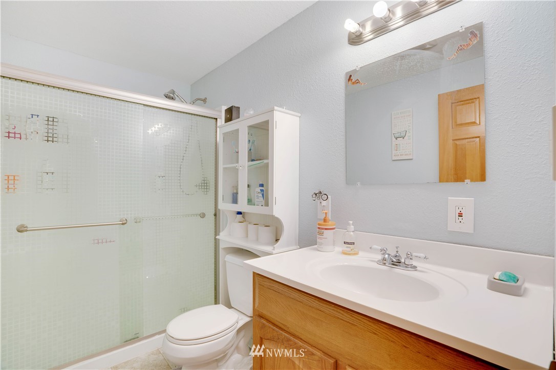 16619 192nd Avenue Southeast Renton, WA 98058 - Photo 10 of 37 a bathroom with a sink a toilet and shower