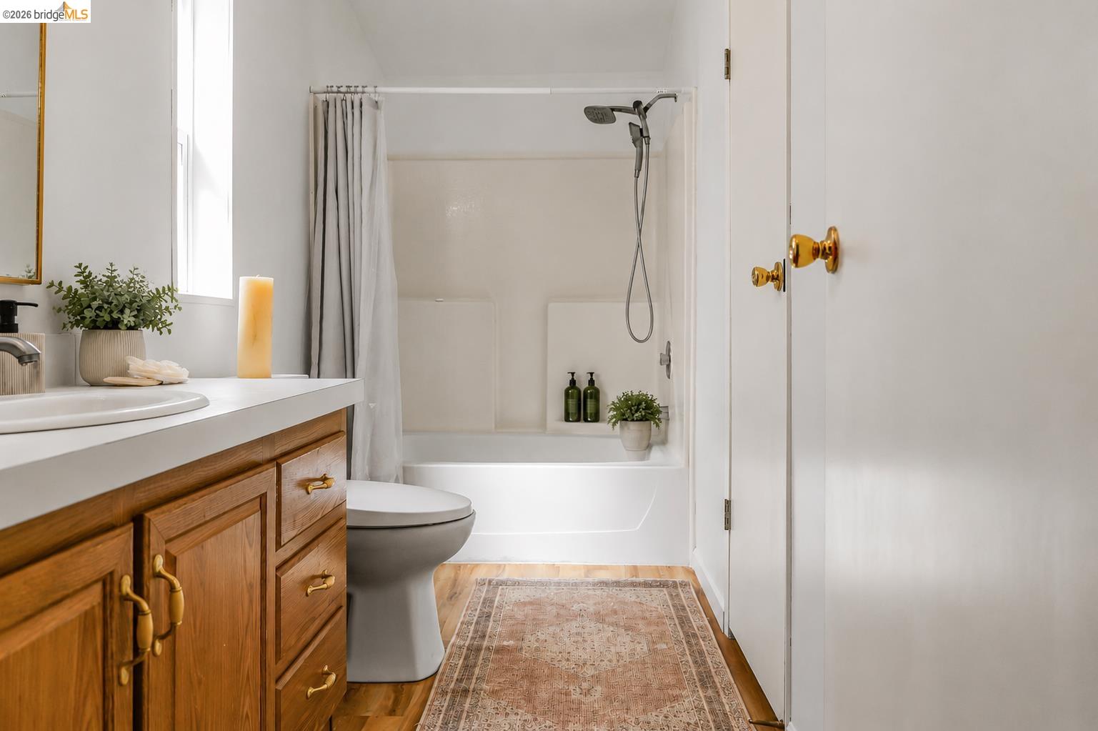 4419 Little John Road Copperopolis, CA 95228 - Photo 13 of 43 Bathroom featuring a wood-finish vanity with gold-tone hardware, white countertop, and an integrated sink