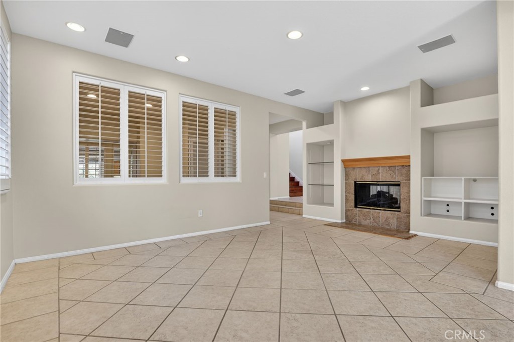 20543 Pesaro Porter Ranch Porter Ranch, CA 91326 - Photo 20 of 67 a view of an empty room with a fireplace and a window