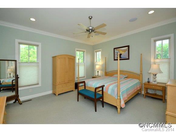 111 Pardo Road Landrum, SC 29356 - Photo 11 of 24 a bedroom with a bed and a chandelier