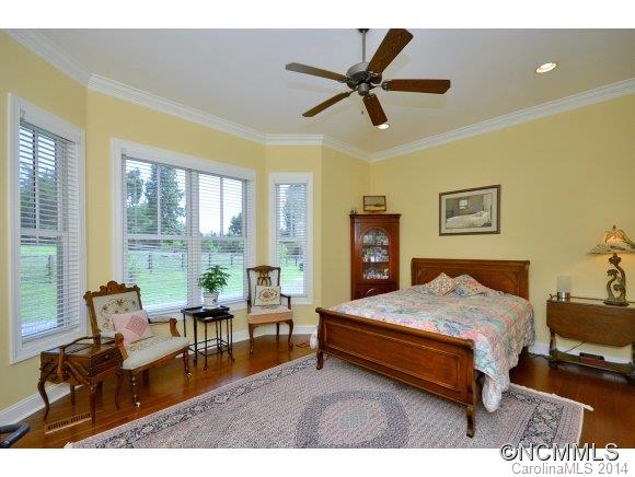 111 Pardo Road Landrum, SC 29356 - Photo 15 of 24 a bedroom with a bed a couch and a large window