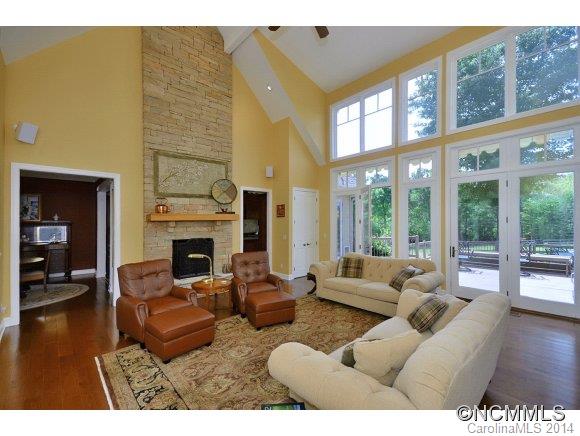 111 Pardo Road Landrum, SC 29356 - Photo 3 of 24 a living room with furniture a fireplace and floor to ceiling windows
