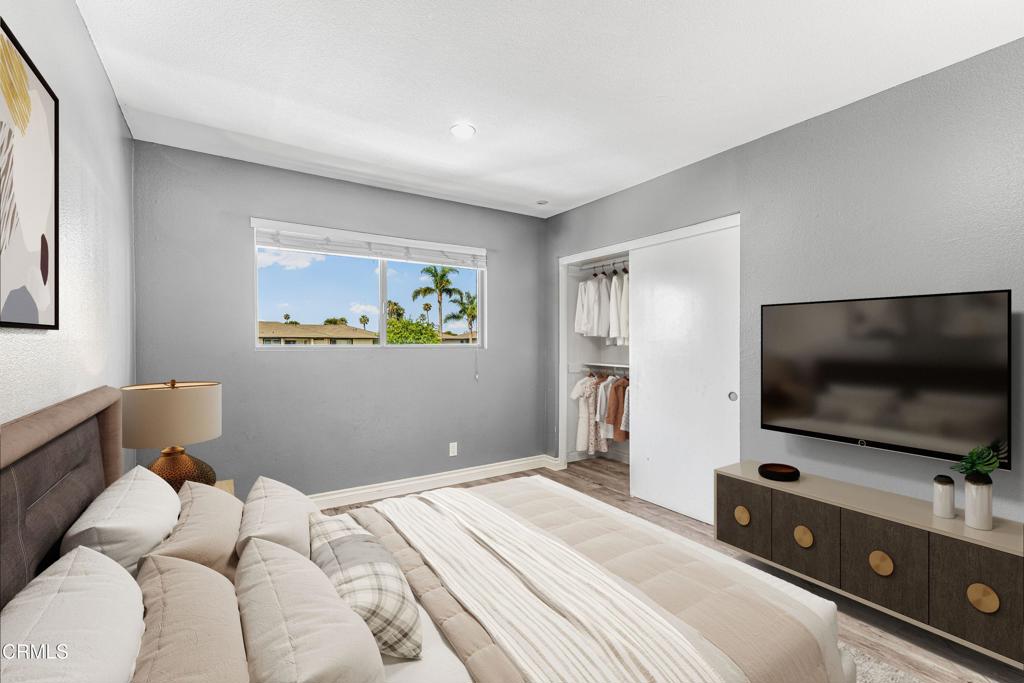 1920 North H Street, Unit 233 Oxnard, CA 93036 - Photo 12 of 26 a bedroom with a flat screen tv and a bed