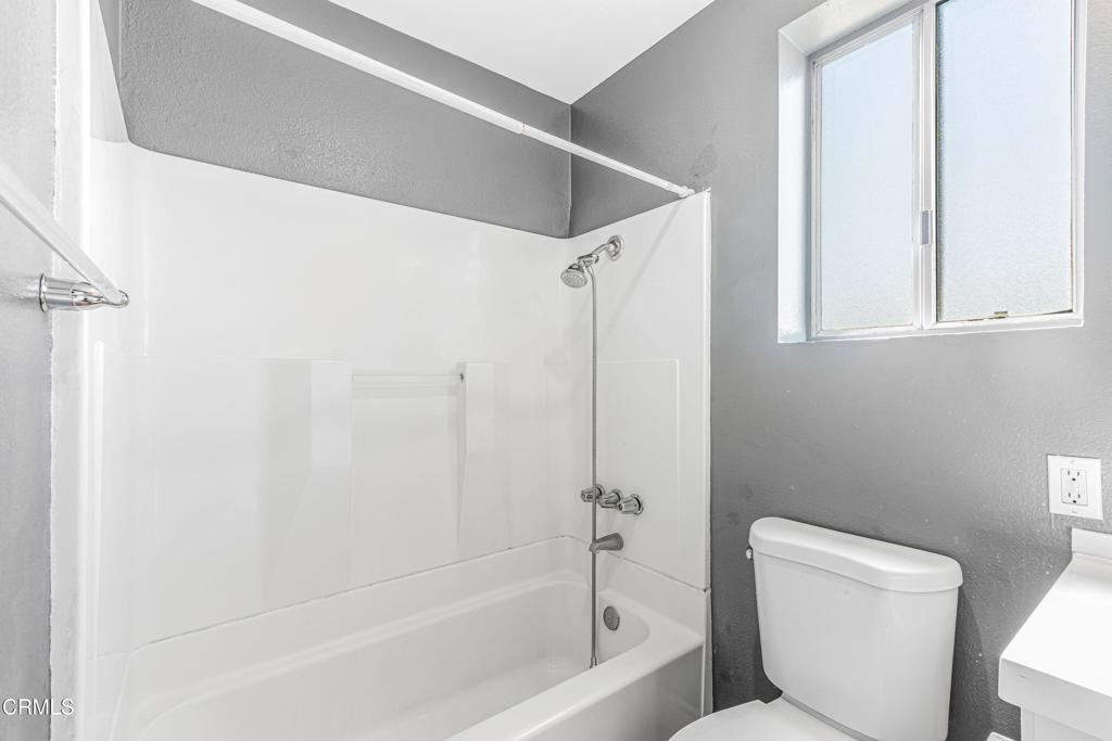 1920 North H Street, Unit 233 Oxnard, CA 93036 - Photo 13 of 26 a bathroom with a toilet and a bathtub