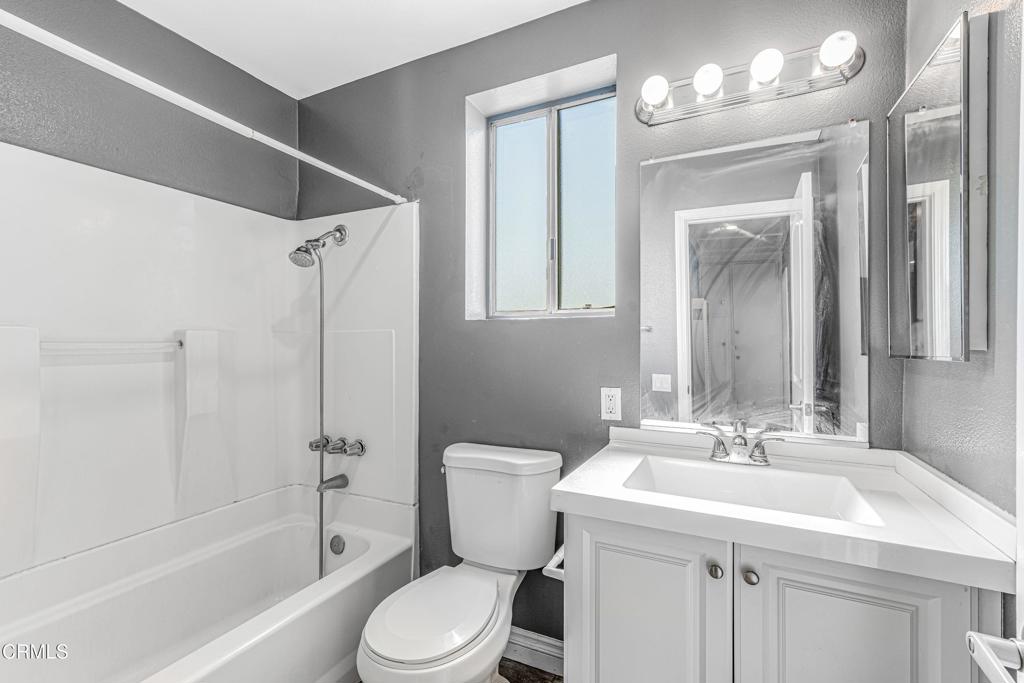1920 North H Street, Unit 233 Oxnard, CA 93036 - Photo 14 of 26 a bathroom with a sink a toilet and shower