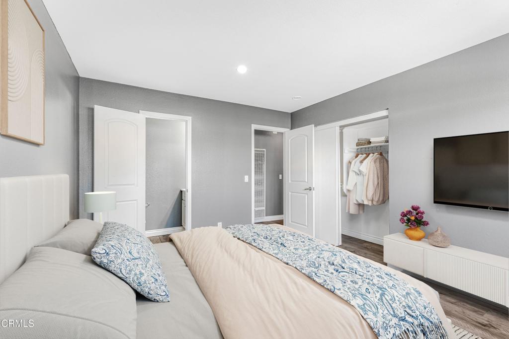 1920 North H Street, Unit 233 Oxnard, CA 93036 - Photo 8 of 26 a bedroom with a bed and a flat tv screen on dresser