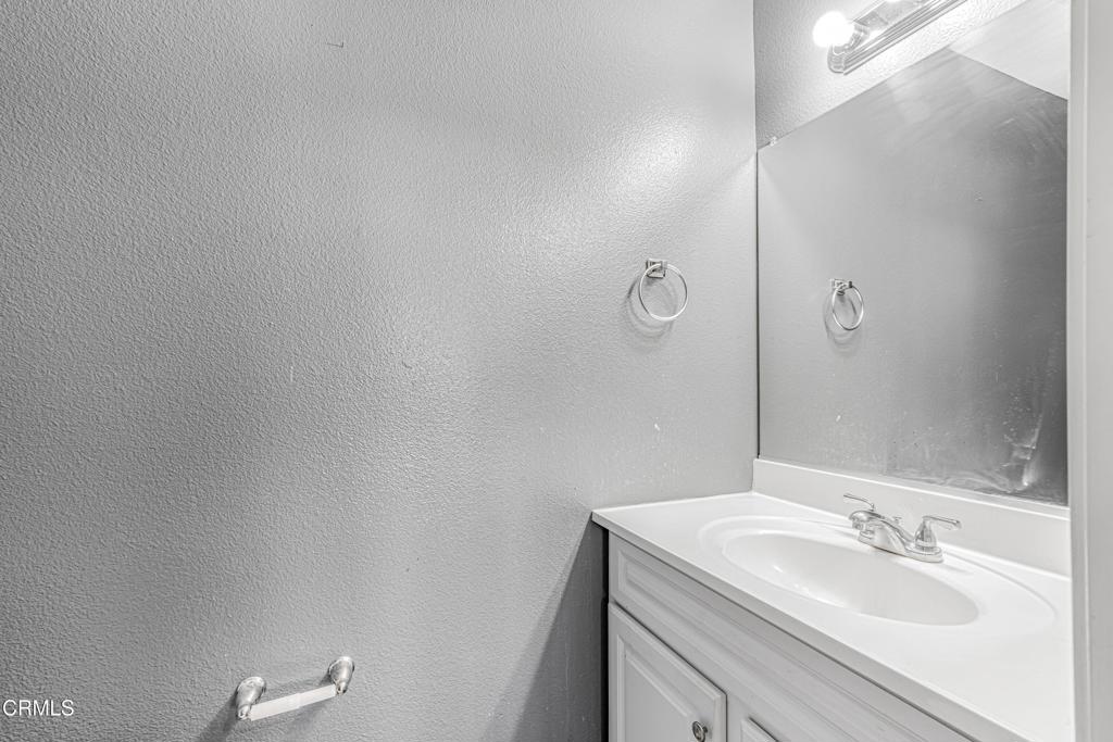1920 North H Street, Unit 233 Oxnard, CA 93036 - Photo 10 of 26 a bathroom with a sink and mirror