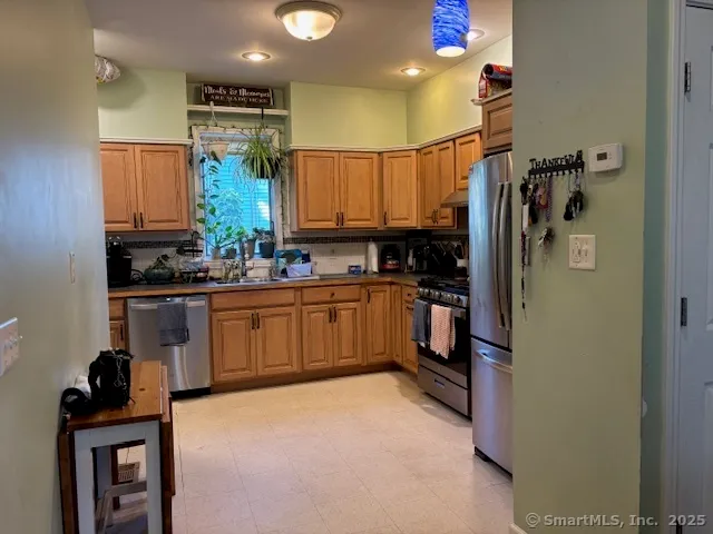 a kitchen with a sink refrigerator and cabinets