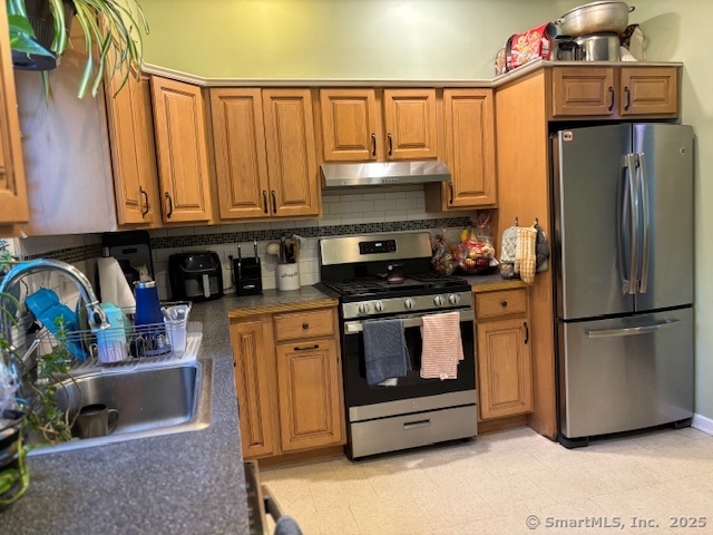 193 Wakelee Avenue Ansonia, CT 06401 - Photo 17 of 38 a kitchen with stainless steel appliances granite countertop a refrigerator a stove and a sink with wooden floor