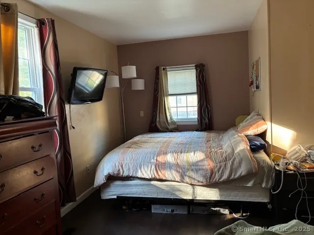 a bedroom with a bed and a mirror