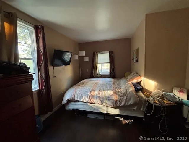 a bedroom with a bed and window