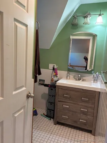 a bathroom with a sink vanity and mirror