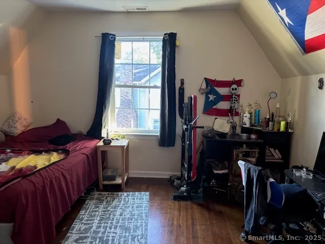 a bedroom with bed and a window