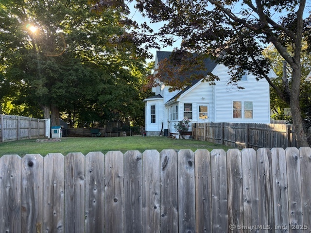 193 Wakelee Avenue Ansonia, CT 06401 - Photo 7 of 38 a view of a house with wooden fence next to a small yard