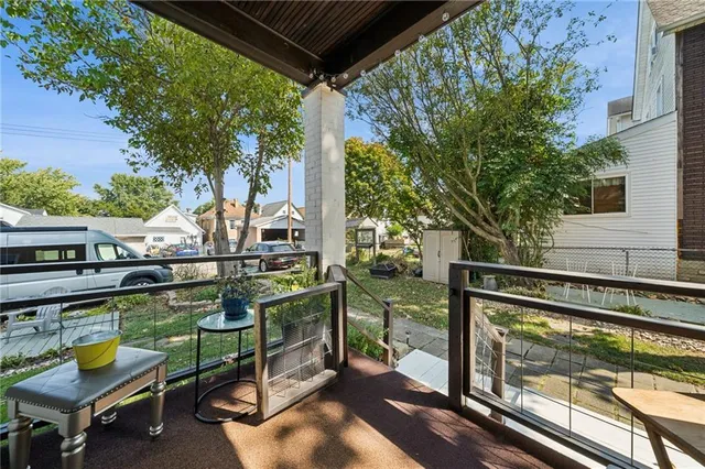 a view of a chairs and table in the balcony