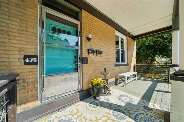 a front view of a house with outdoor seating