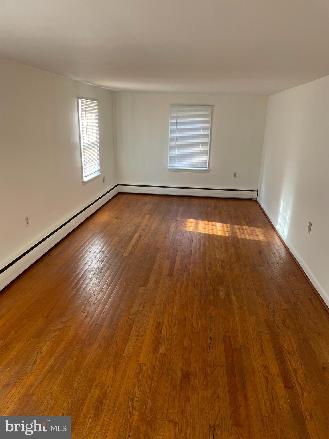10524 Stull Road Thurmont, MD 21788 - Photo 66 of 91 an empty room with wooden floor and windows