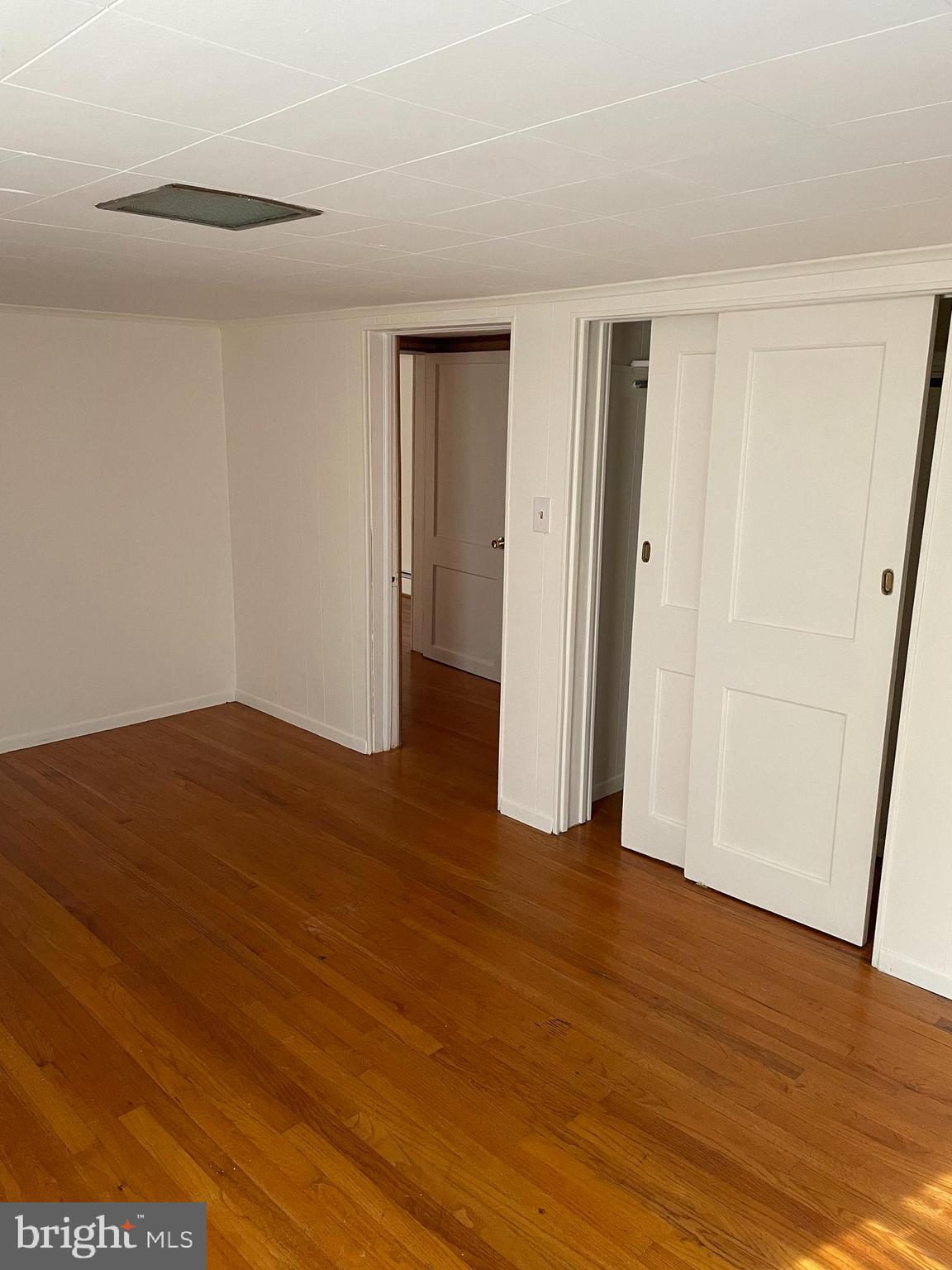 10524 Stull Road Thurmont, MD 21788 - Photo 73 of 91 a view of an empty room with wooden floor and closet