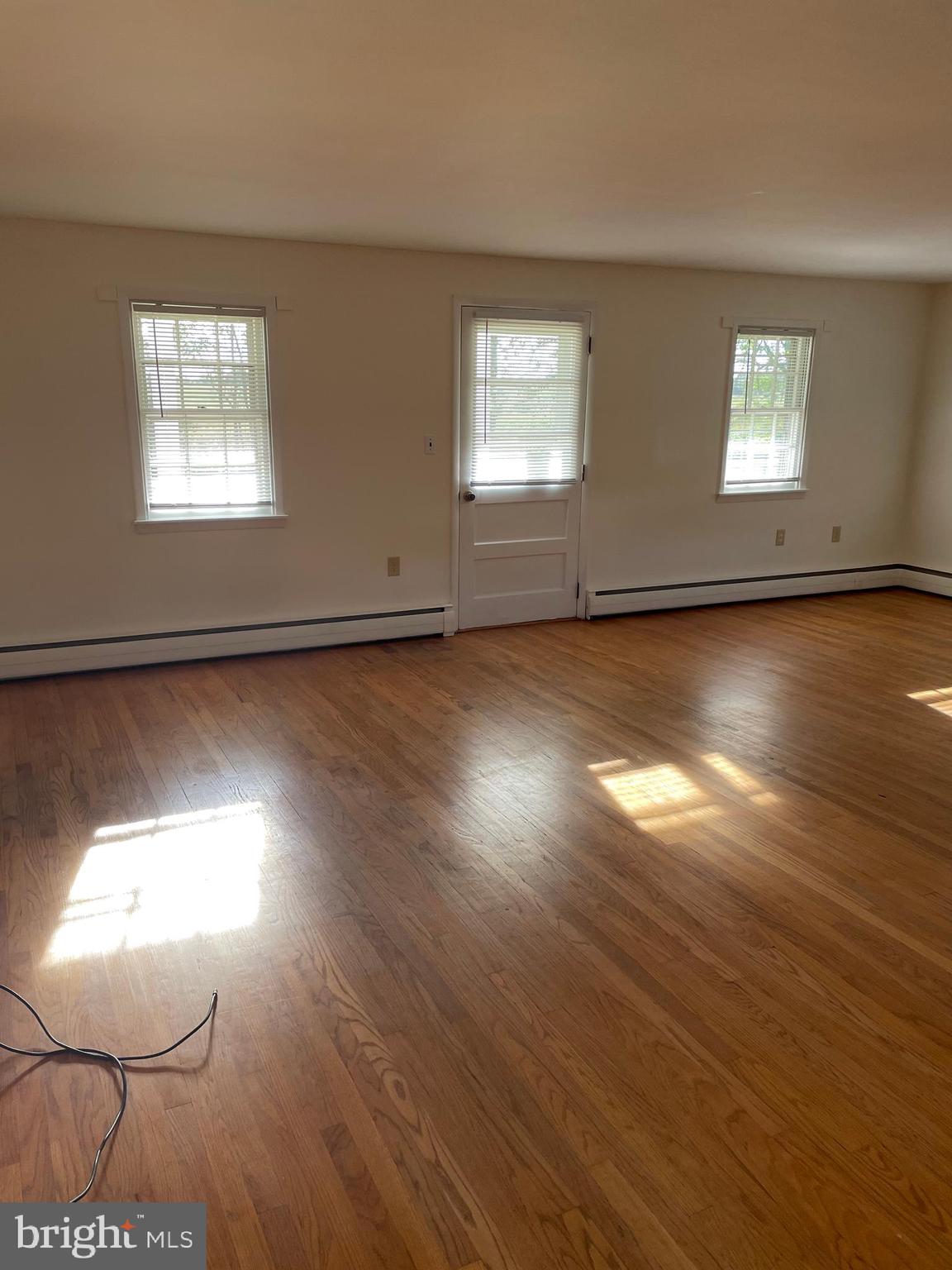 10524 Stull Road Thurmont, MD 21788 - Photo 86 of 91 a view of an empty room with wooden floor and a window