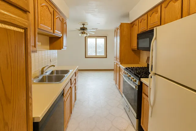 a kitchen with stainless steel appliances granite countertop a stove a sink and a refrigerator