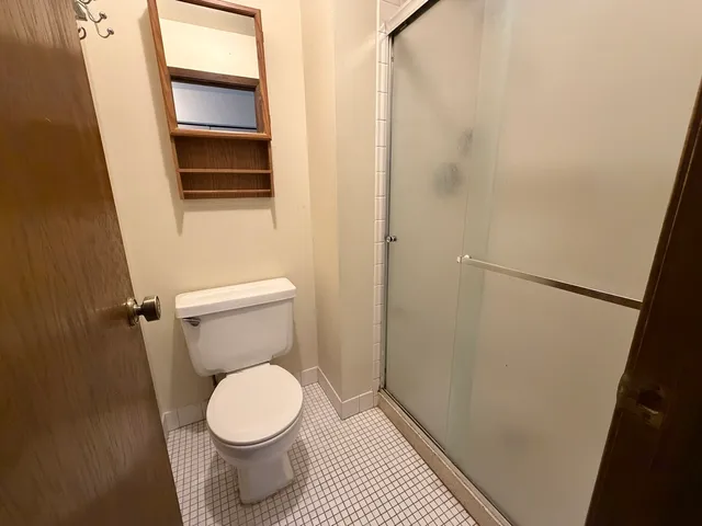 a white toilet sitting in a bathroom next to a sink