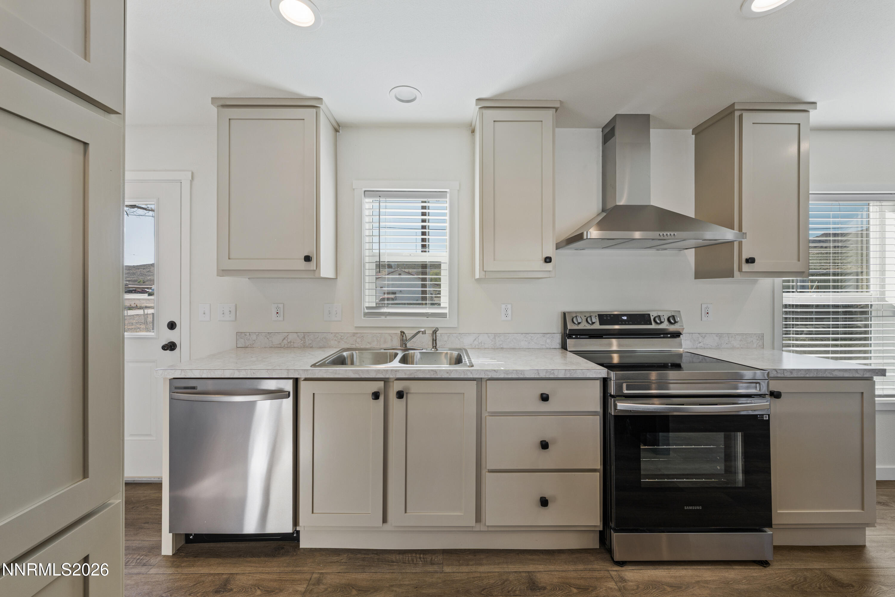 105 Fireman Row Dayton, NV 89403 - Photo 2 of 16 a kitchen with stainless steel appliances granite countertop a stove and a sink